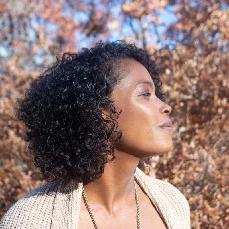 Zee Clarke founder of Reclaiming Flow LLC and author of Black People Breathe looks into the distance